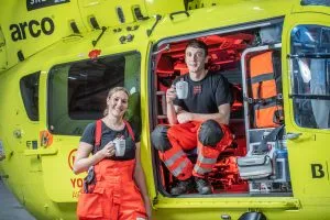 Image of paramedics sat in helicopter with hot chocoalte
