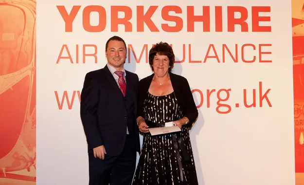 Image of YAA Volunteer Liz Storey receiving an award