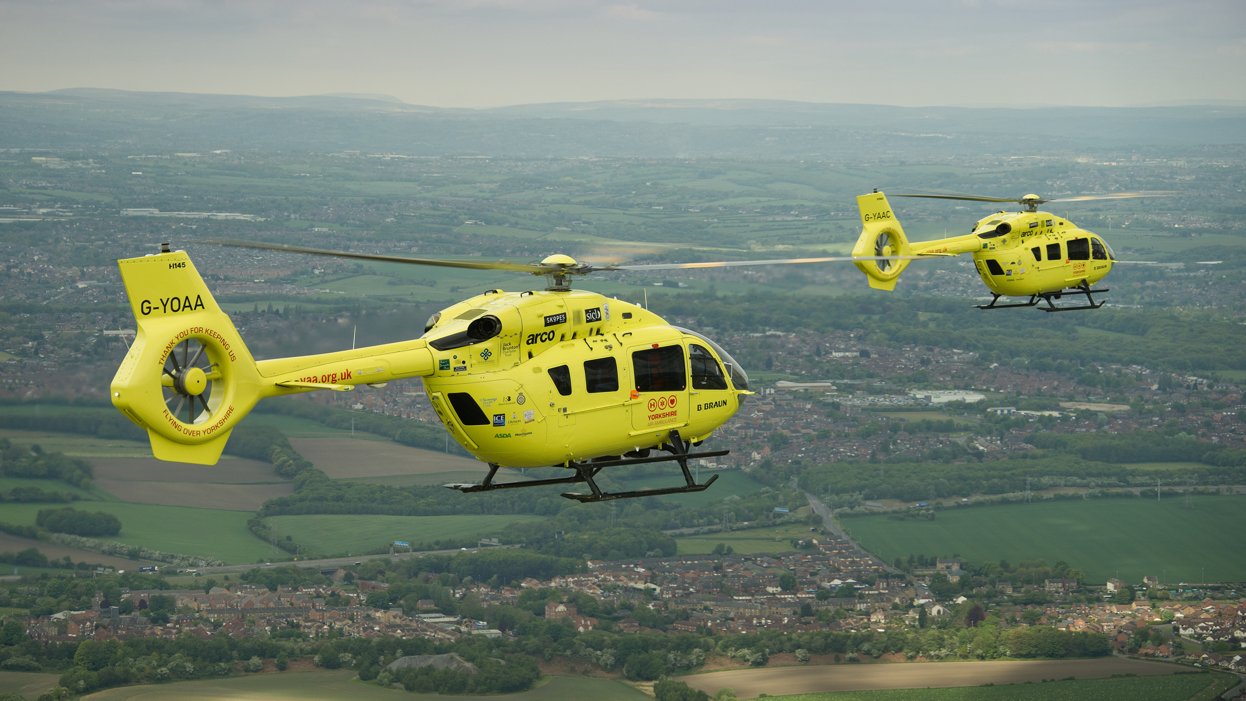 Image of both Yorkshire Air Ambulance helicopters flying over Yorkshire