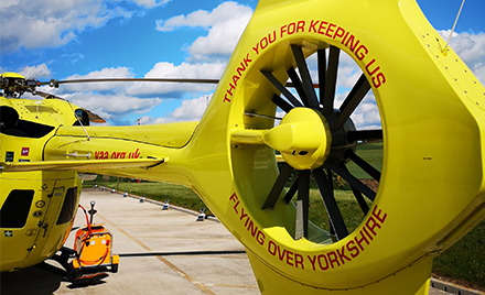 This image shows the back of one of the Yorkshire Air Ambulance Helicopters which displays the words Thank you for keeping us flying over Yorkshire