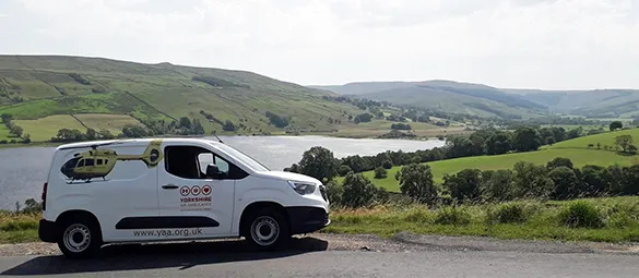 Image shows a Yorkshire Air Ambulance fundraising van on the road above Semerwater in North Yorkshire