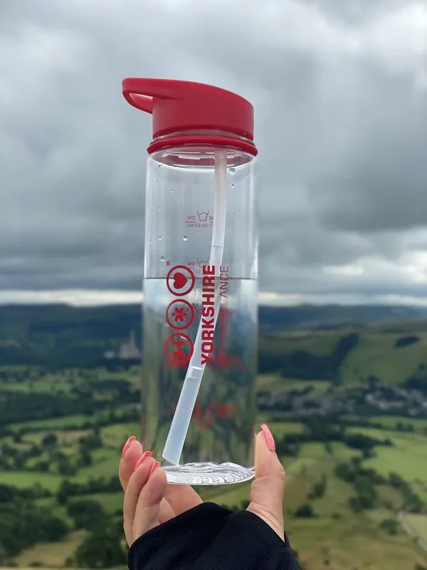 Photo of Yorkshire Air Ambulance Water Bottle being held up with fields in the background