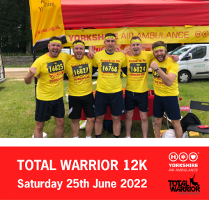 Photo of a team wearing Yellow Yorkshire Air Ambulance T-Shirts and race numbers, in front of red and yellow Yorkshire Air Ambulance stand. Words saying Total Warrior 12K Saturday 25th June 2022 next to Yorkshire Air Ambulance and Total Warrior logos