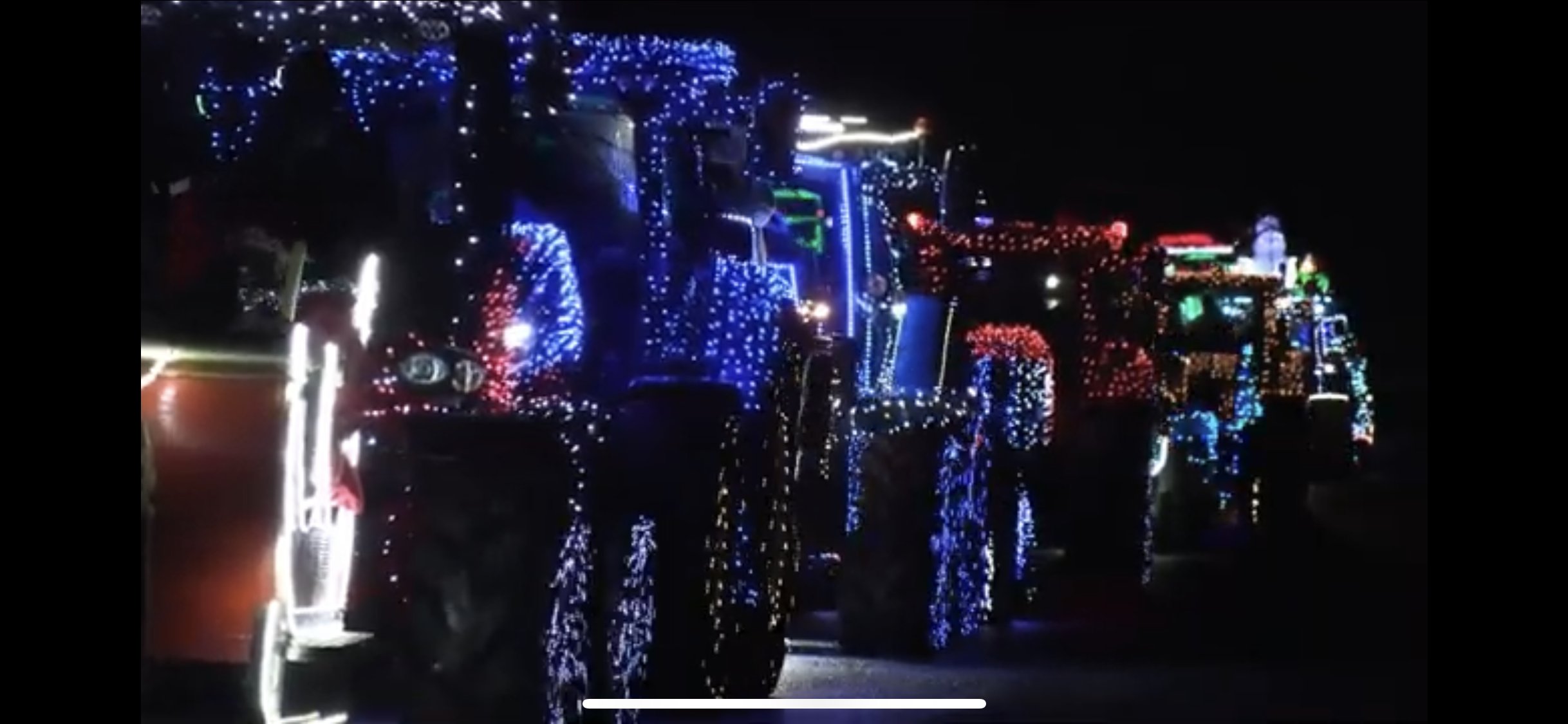 Photo of tractors with Christmas lights on at night