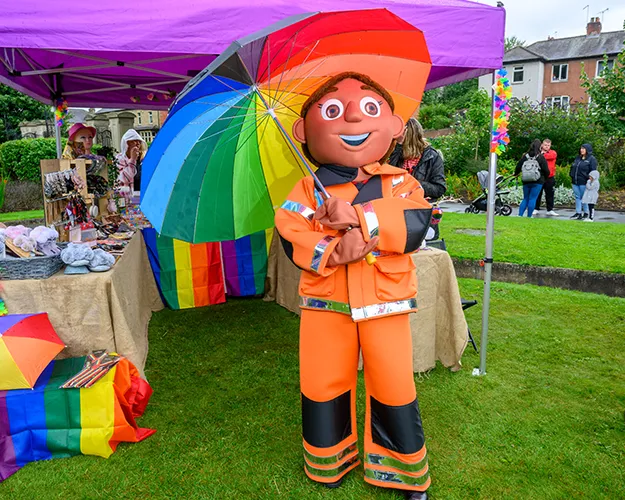 Yorkshire Air Ambulance mascot Dr Priti holding a colourful umbrella