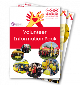 Image of the front cover of the Yorkshire Air Ambulance Volunteer Information Pack and some other pages fanned out underneathe
