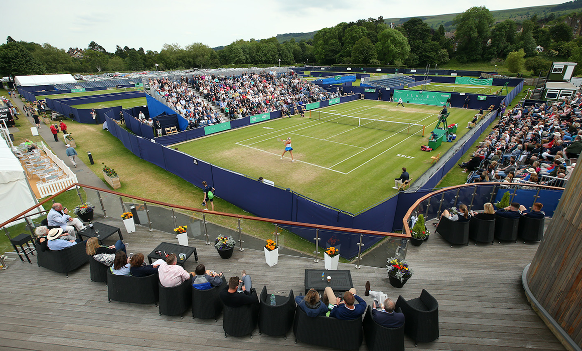 A photo of a tennis match taking place at the Ilkley Lawn Tennis and Squash Club