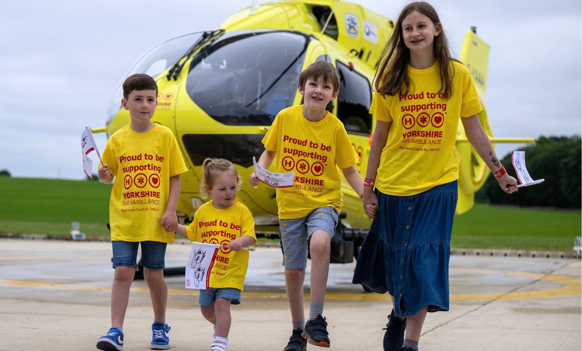 Children running in front of a helicopter