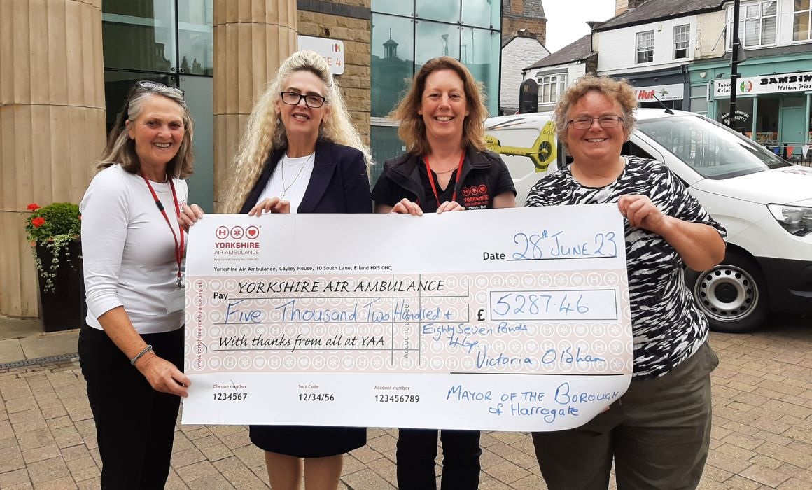 4 women holding a large cheque