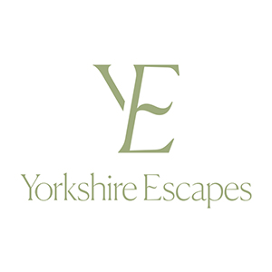 A green logo on a white background with the words 'Yorkshire Escapes'