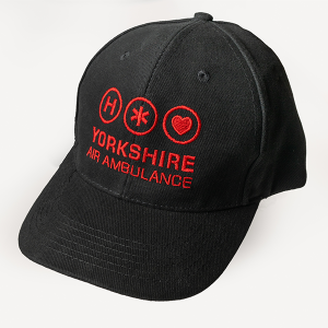 A black baseball cap with a red logo which contains the words 'YORKSHIRE AIR AMBULANCE'.