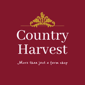 White and gold logo on a burgundy background, with the working Country Harvest More than just a farm shop.