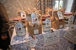 A close up of a table containing jars and bags of cookie mix ingredients.