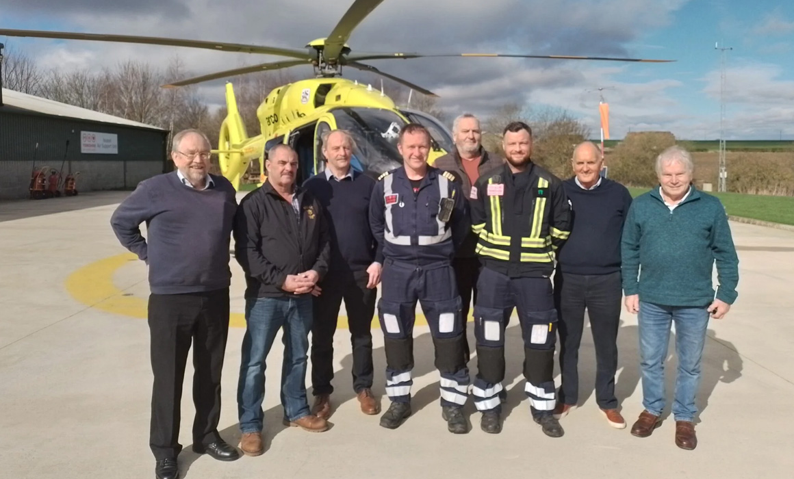 Freemasons with helicopter crew
