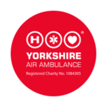 A red circle with the white Yorkshire Air Ambulance logo in the middle.
