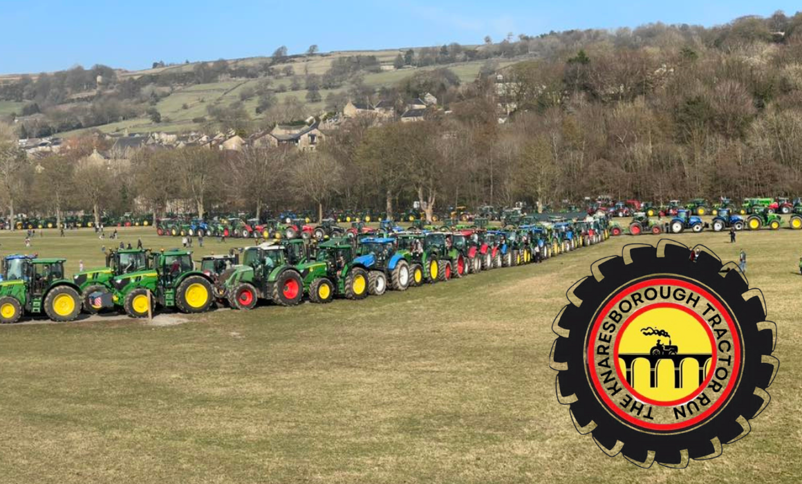 A line of tractors in a field