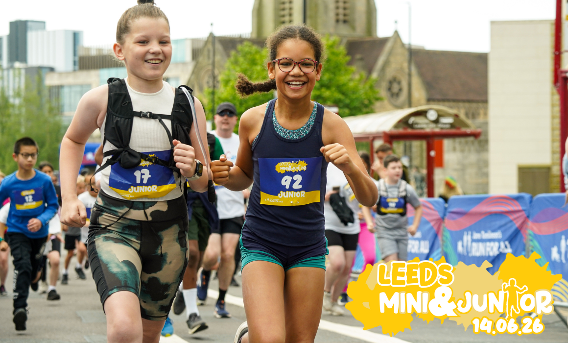 Run for All Junior & Mini – Web Event Image Two children are running a race, wearing race numbers. The words Leeds Mini & Junior are in the corner of the image.
