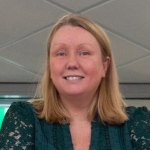 Head and shoulders image of a lady with shoulder length blonde hair.